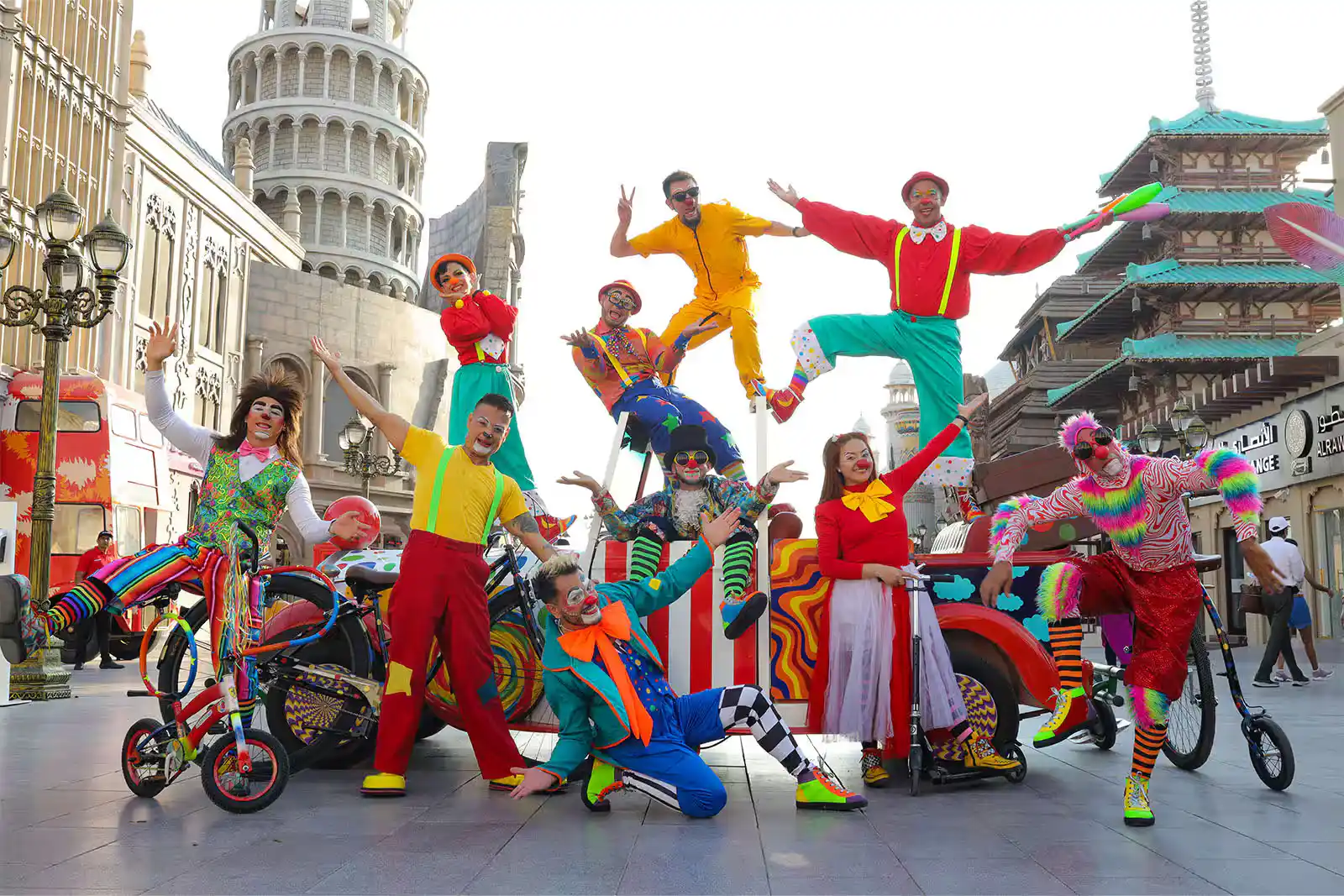  Joyful circus clowns entertain visitors on colorful bikes at Global Village Dubai.