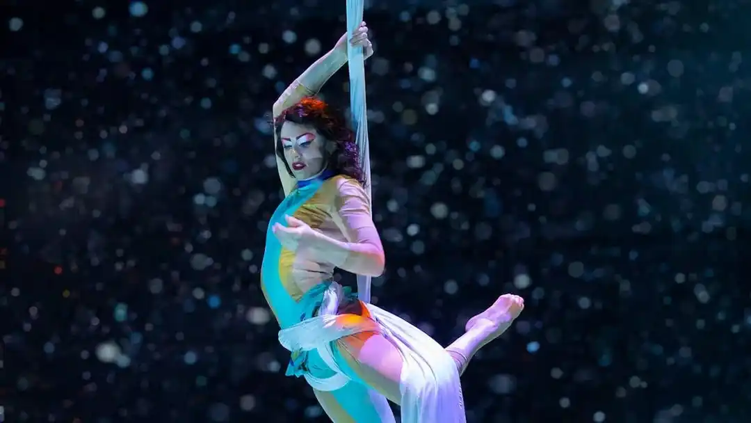 Elegant aerial silk performance captured live during La Perle by Dragone show in Dubai.